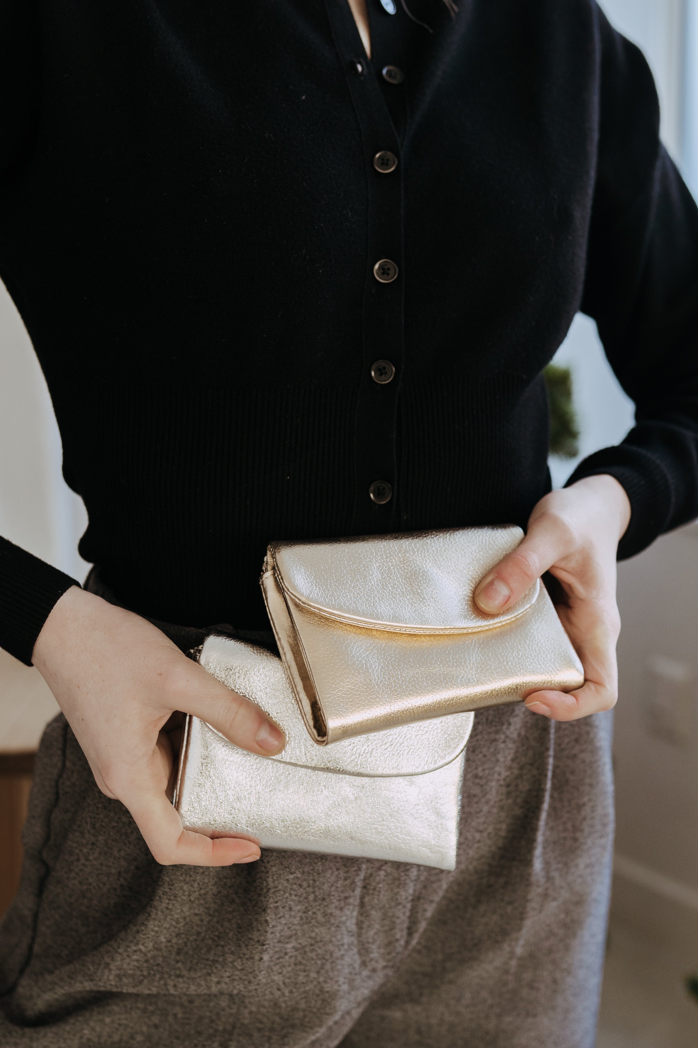 Card holder sitting on a stack of papers with a backpack 