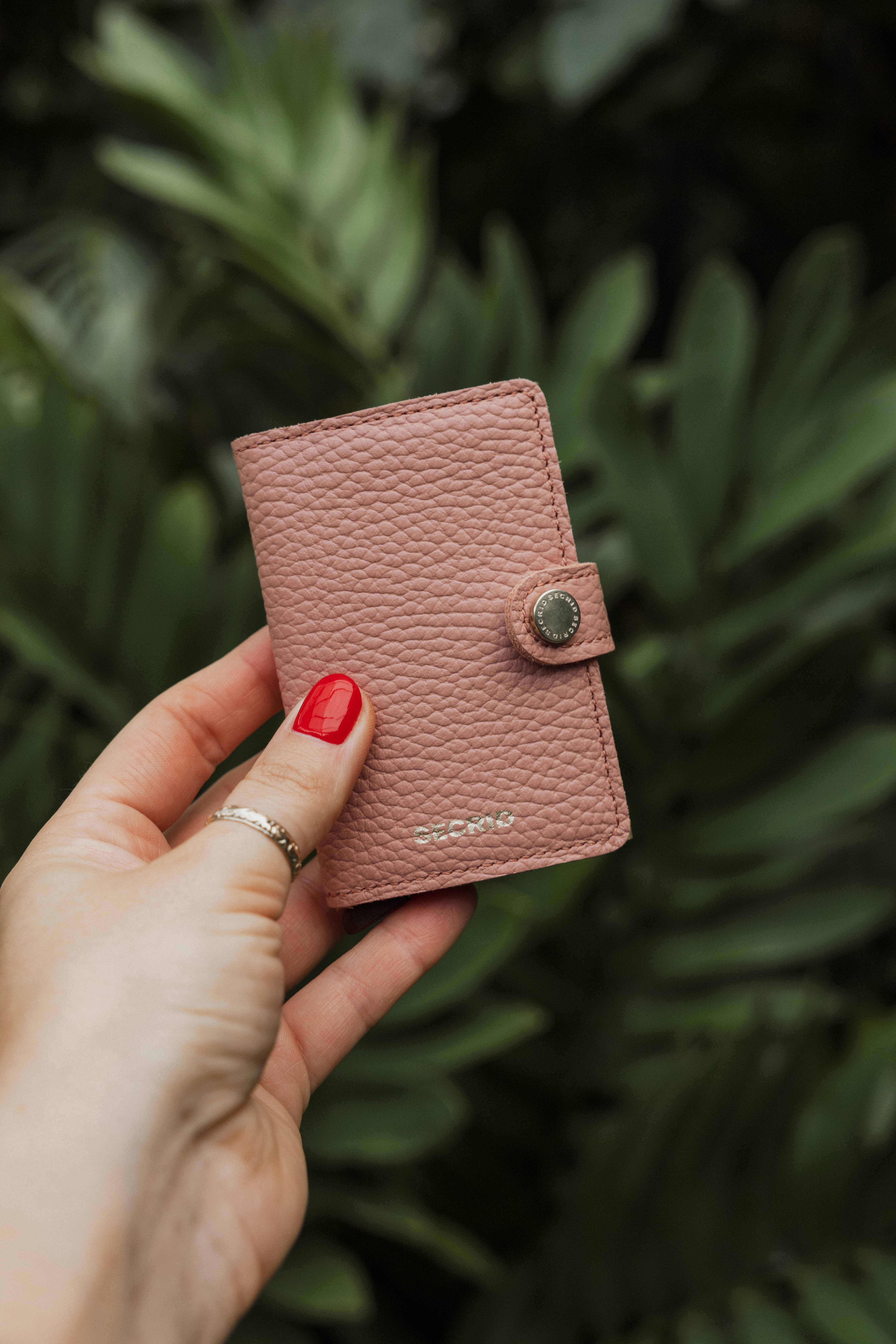 Card holder sitting on a stack of papers with a backpack 
