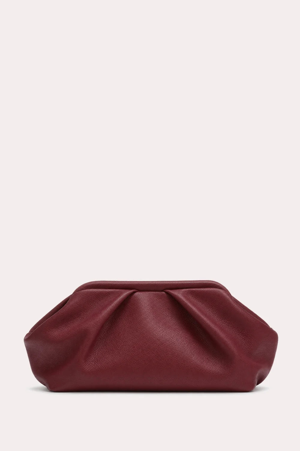 A pleated leather clutch bag in a deep burgundy red, photographed against a solid off-white background.